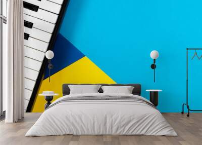 Top view to piano on yellow and blue background. Music learning concept. Top view Wall mural