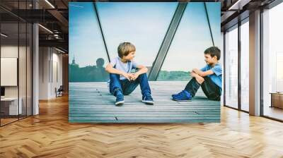 Two boys friends talking with each other Wall mural