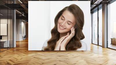 cute lovely young girl with fresh skin and healthy hair smiling on white Wall mural