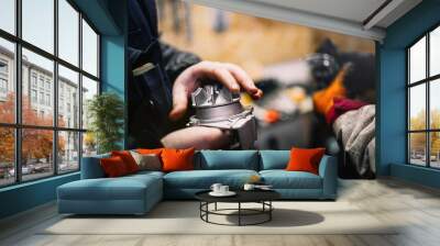 Automotive water pump of the engine cooling system in the hands of an auto mechanic, replacement of the pump with a metal impeller. Wall mural