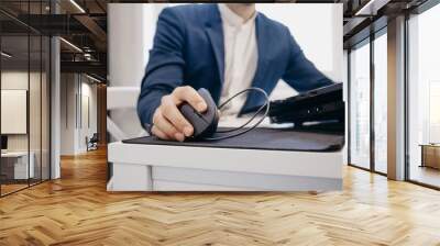 office worker uses an ergonomic vertical computer mouse Wall mural