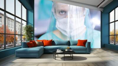 surgeon in medical uniform and protective face shield, specialist glasses. Virus protection concept. Wall mural