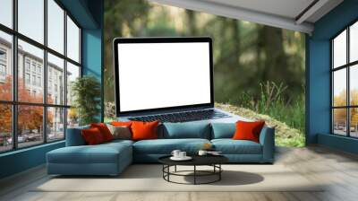 Laptop outside concept. Empty copy space, blank screen mockup. Soft focus laptop in nature background. Ecology travel and work outside office concept. Wall mural