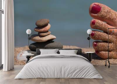 Lady 's feet relax close to zen stone tower Wall mural