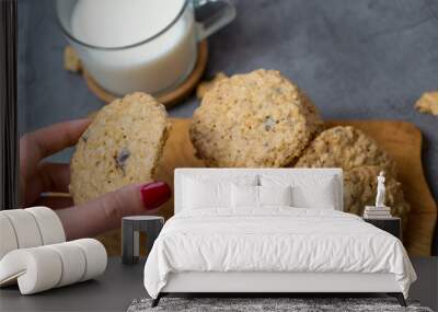 Oatmeal cookies and milk on a wooden board and gray background Wall mural