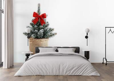 Small Christmas Tree with Red Bow in Burlap Pot on White Background Wall mural