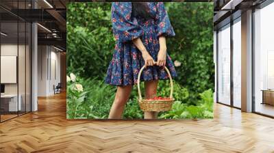 Girl with a basket of cherries in the garden Wall mural