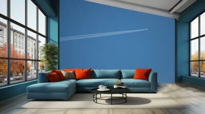 Plane flying on a blue sky, condensation line. Wall mural