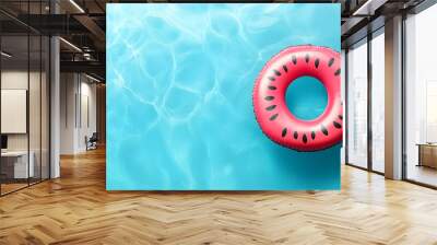 An inflatable watermelon swim ring floating on a blue swimming pool Wall mural