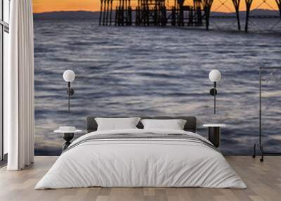 Beautiful long exposure sunset over ocean with pier silhouette c Wall mural