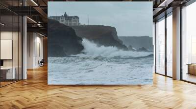 Crashing waves during storm on beach at Church Cove in Cornwall UK landscape image Wall mural