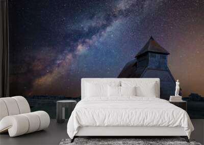 Vibrant Milky Way composite image over landscape of Ancient Medieval church Wall mural