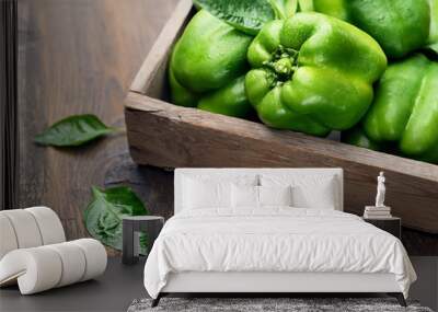 green bell peppers in a box on a wooden background Wall mural