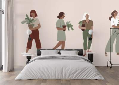 Girls holding house plants in pots - urban jungle concept Wall mural