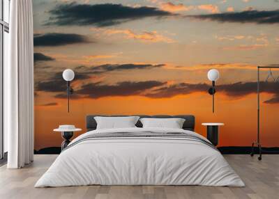 sun hidden behind the silhouette of a mountain. summer sunset in yellow and orange colours. the sun' Wall mural