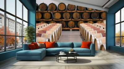 Wooden wine barrels for storage in wine cellar Wall mural