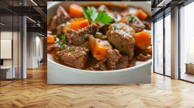 A beef stew with tender chunks of meat and vegetables, served in a white bowl with a garnish of fresh parsley. Wall mural