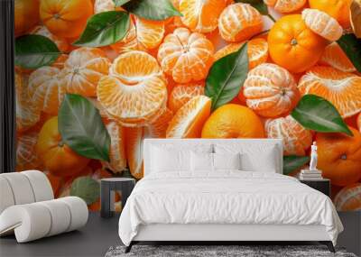 A collection of tangerines and tangerine peels arranged to create a lively and colorful background with a hint of green from the leaves. Wall mural