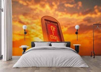 A thermometer reading high temperatures against a backdrop of a fiery orange sky and heat distortion effects. Wall mural