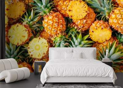 A vibrant pineapple pattern fills the background with bright yellow and green hues, showcasing the fruit's textured surface in a seamless, repeating design. Wall mural