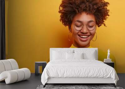 A young woman with a bright smile on her face as she discovers a new item she loves while online shopping.  Wall mural