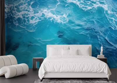 Blue ocean water with vibrant turquoise hues and smooth surface Wall mural