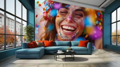 Excited woman at carnival covered in rainbow confetti Wall mural