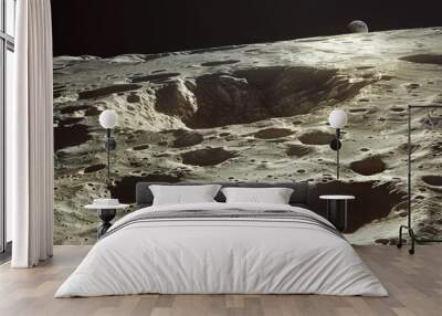 Rocky moon surface with craters and dusty landscape Wall mural