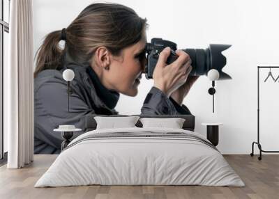 Woman photographer looking through the camera viewfinder Isolated on white background Wall mural