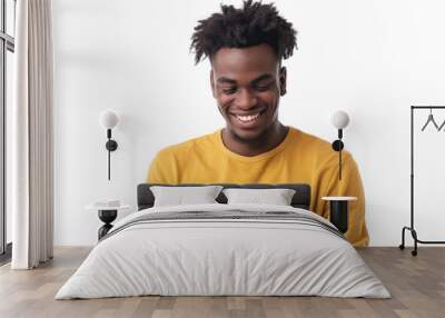 Young man smiling while looking at mobile phone Isolated on white background Wall mural