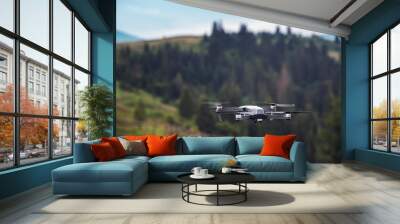 drone quadcopter with digital camera flying in mountain Wall mural