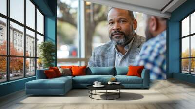 An African American man participating in a job interview in a business office setting. Wall mural