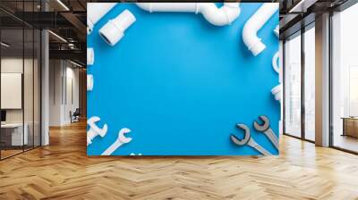 A blue background shows plumbing tools and equipment Wall mural