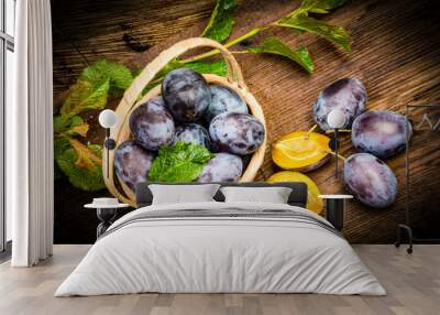 garden plums on a wooden table close up Wall mural