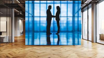 Two Innovative Leaders Embracing Progress: A Silhouette Handshake Against a Sky Blue Backdrop Wall mural