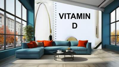 In the notebook is the text of VITAMIN D, next to a stethoscope and a pen. Wall mural