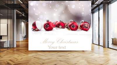 Christmas red balls in snow with blur celebration background.  Wall mural