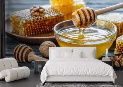 Assortment of honey products honeycombs, nuts in honey, beeswax in table. Healthy organic honey dipping in jar, closeup. Honey pouring in glass bowl Wall mural