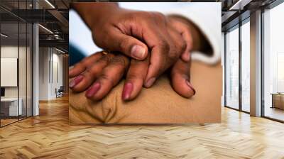 close up detail of black hands of grandmother and granddaughter over each other. commitment, aging, care, support, unity concept. . Wall mural