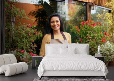 Entrepreneur poses for portrait in plant shop. Wall mural