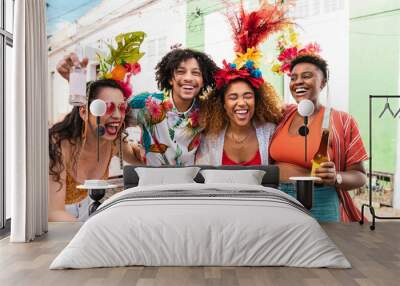 Group of people enjoying street Carnival festival. Friends laughing outdoors in costumes. Wall mural