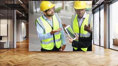 business people working off-site, multiracial engineer are having stress while discuss work by using tablet computer Wall mural