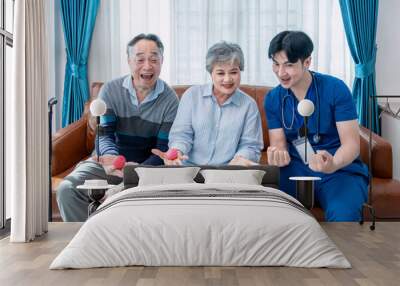 young male assistant in uniform advice asian senior couple exercise hands with a ball,home health care nurse visit asian senior family at home,concept elderly health care,homecare,home health nursing Wall mural