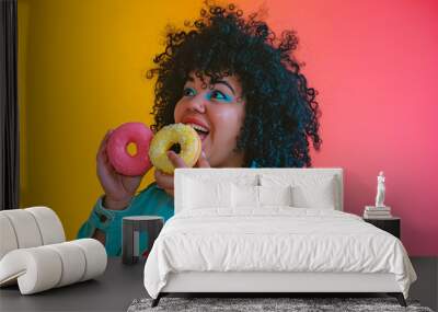 Cheerful curvy woman holding donuts. Plus size young woman ready to eat donut with frosting. Wall mural