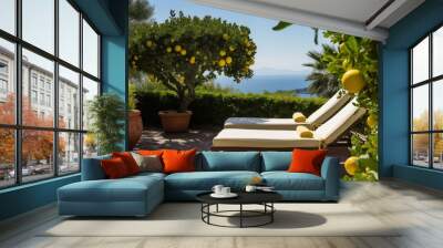 Sunbed loungers with towels on the terrace in the shade of lemon trees, overlooking the sea. Two sun loungers with sea view and Mediterranean landscape. Wall mural