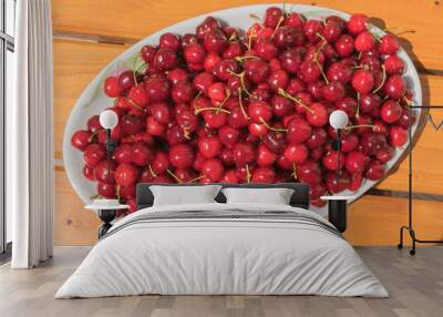 red and juicy cherries on a white plate Wall mural