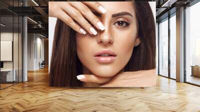 Beautiful woman portrait, skin care concept Portrait of female hands with french manicure nails touching her face. Spa. Girls makeup and cosmetics. Facial treatment. Wall mural