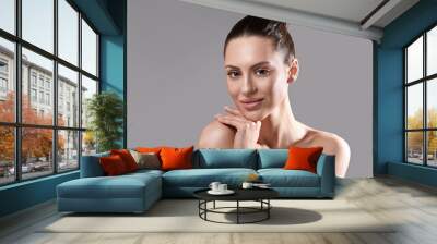 Beautiful young woman with clean perfect skin. Portrait of beauty model with natural nude make up. Spa, skincare and wellness. Wall mural