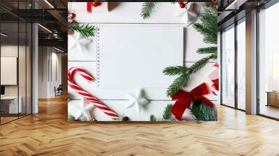 Christmas decoration. Creative layout made of Christmas tree branches with paper card note. Flat lay. Nature New Year concep Wall mural