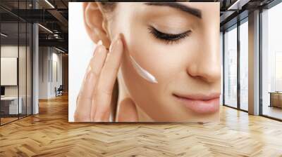 Facial Care. Female Applying Cream.Portrait Of  Young Woman With Cosmetic Cream On Skin. Closeup Of Beautiful Girl With Beauty Product On Soft Skin, Natural Makeup Touching Face. High Resolution Wall mural